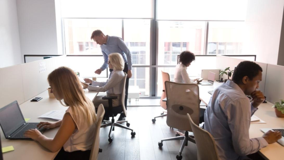 Students collaborating on video production project with camera equipment